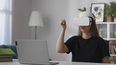 woman-is-viewing-pictures-using-modern-vr-head-mounted-display-gesticulating-by-hands-for-control-medium-female-portrait-at-home